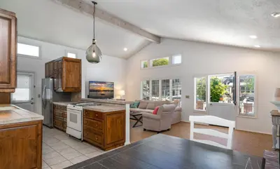 a kitchen and living room with a couch and a table at 210 Opal Ave Front House in Newport Beach