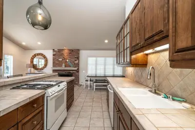 a kitchen with wooden cabinets and a white stove top oven at 210 Opal Ave Front House in Newport Beach