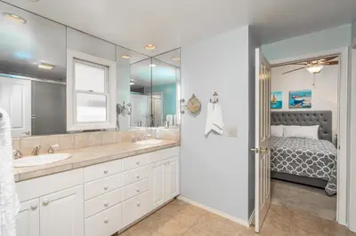 a bathroom with two sinks and a bed at 210 Opal Ave Front House in Newport Beach
