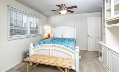 a bedroom with a bed and a ceiling fan at 210 Opal Ave Front House in Newport Beach