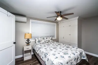 a bedroom with a bed and a ceiling fan at 129 Opal Ave A in Newport Beach