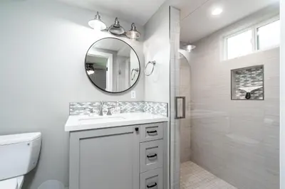 a white bathroom with a sink and a shower at 129 Opal Ave A in Newport Beach
