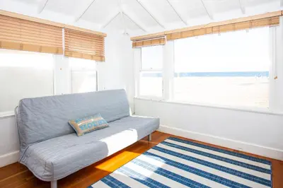 a living room with a couch and a window at 1002 E Oceanfront in Newport Beach