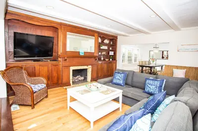 a living room with a couch and a fireplace at 1002 E Oceanfront in Newport Beach