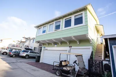 a golf cart parked in front of a house at 1002 E Oceanfront in Newport Beach