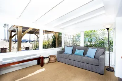 a living room with a couch and a large window at 1002 E Oceanfront in Newport Beach