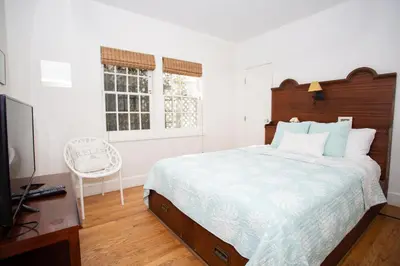 a bedroom with a large bed and a television at 1002 E Oceanfront in Newport Beach