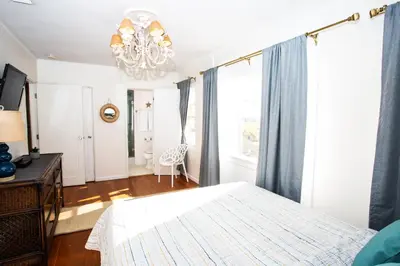 a bedroom with a bed and a chandelier at 1002 E Oceanfront in Newport Beach