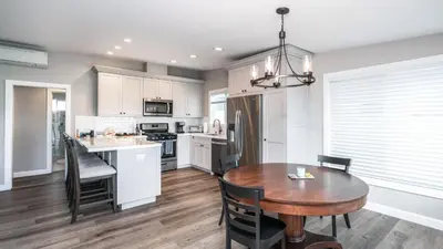 a kitchen and dining room with a wooden table at 129 Opal Ave A & B in Newport Beach