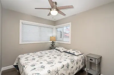 a bedroom with a bed and a ceiling fan at 129 Opal Ave A & B in Newport Beach