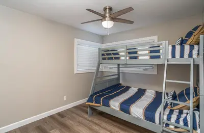 a bedroom with bunk beds and a ceiling fan at 129 Opal Ave A & B in Newport Beach