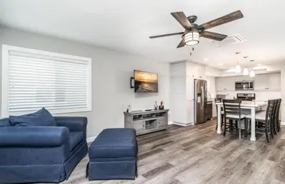 a living room with a couch and a ceiling fan at 129 Opal Ave A & B in Newport Beach
