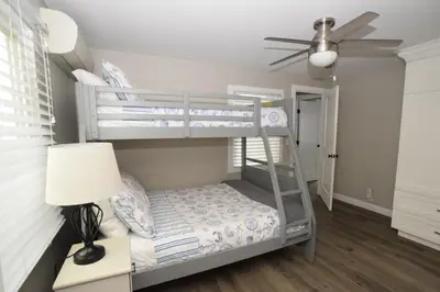 a bedroom with a bunk bed and a ceiling fan at 129 Opal Ave A & B in Newport Beach