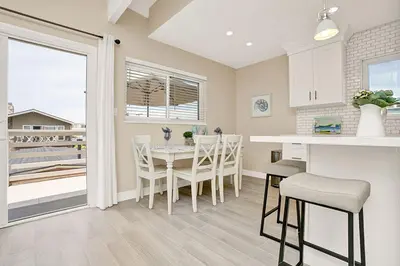 a kitchen and dining room with a table and chairs at 114 Forty Second Street B in Newport Beach
