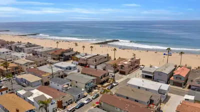 an aerial view of a beach with buildings and palm trees at 114 Forty Second Street B in Newport Beach