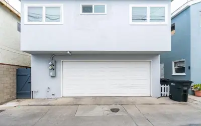 a white house with a white garage door at 129 Opal Ave B in Newport Beach