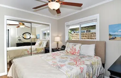 a bedroom with two beds and a ceiling fan at 313 E Bay Ave A & B in Newport Beach
