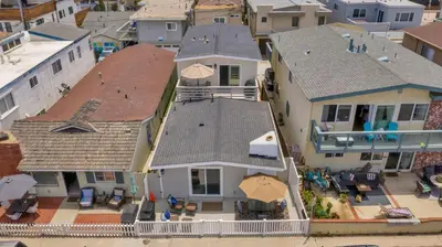 an aerial view of a house with chairs and umbrellas at 114 Forty-Second Street A in Newport Beach