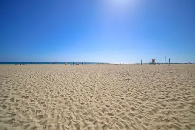a sandy beach with footprints in the sand at 114 Forty-Second Street A in Newport Beach