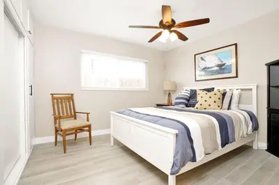 a bedroom with a bed and a ceiling fan at 114 Forty-Second Street A in Newport Beach