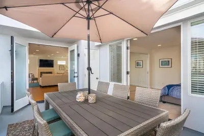 a wooden table with an umbrella on a patio at 310 and a half Iris Ave in Newport Beach