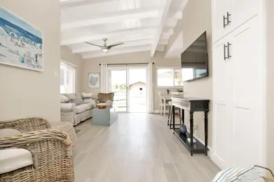 a living room with a fireplace and a piano at 114 Forty Second Street A and B in Newport Beach