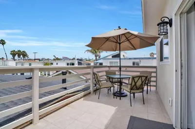 a patio with a table and chairs and an umbrella at 114 Forty Second Street A and B in Newport Beach