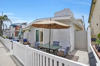 a patio with a table and an umbrella at 114 Forty Second Street A and B in Newport Beach
