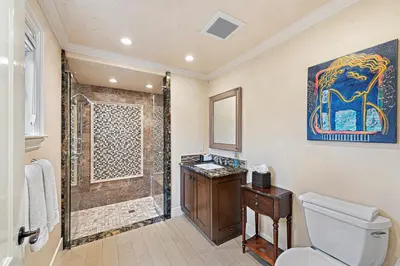 a bathroom with a shower and a toilet and a sink at Villa Rustico at the Retreat in Laguna Beach in Laguna Beach