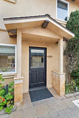 a house with a black door and a window at Villa Rustico at the Retreat in Laguna Beach in Laguna Beach