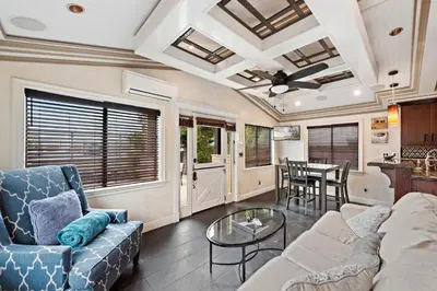 a living room with a couch and a table at Villa Palazzo D'Stella at the Retreat in Laguna Beach