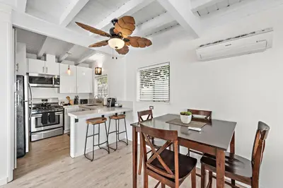 a kitchen with a dining table and a ceiling fan at Sleepy Hollow Villas #2 in Laguna Beach in Laguna Beach