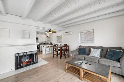 a living room with a couch and a fireplace at Sleepy Hollow Villas #2 in Laguna Beach in Laguna Beach