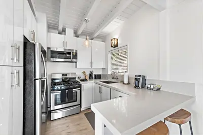 a kitchen with white cabinets and a white counter top at Sleepy Hollow Villas #2 in Laguna Beach in Laguna Beach