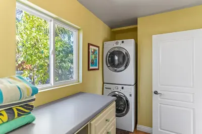 a laundry room with a washer and dryer and a window at Luxury Beach House. Pool/Hot Tub! Walk to Beach! in Carlsbad