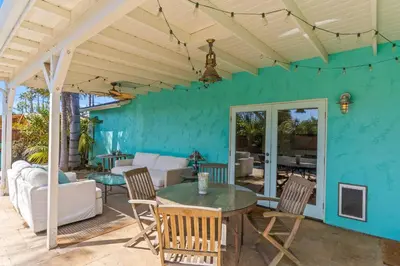 a patio with a table and chairs at Luxury Beach House. Pool/Hot Tub! Walk to Beach! in Carlsbad