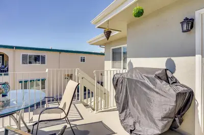 a patio with a table and chairs on a balcony at Newport Beach Vacation Rental Steps to Shore! in Newport Beach