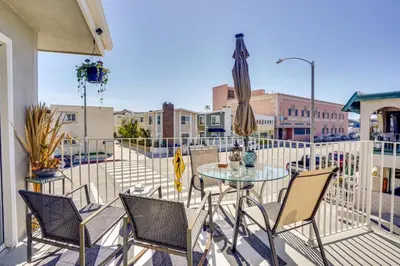 a patio with a table and chairs on a balcony at Newport Beach Vacation Rental Steps to Shore! in Newport Beach