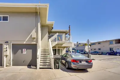 a car parked in front of a building with a staircase at Newport Beach Vacation Rental Steps to Shore! in Newport Beach