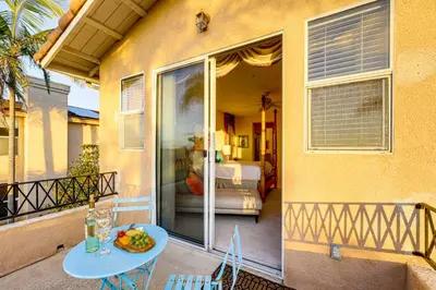 a table with a plate of food on a balcony at 1 Mi to the Beach! Ocean-View Encinitas Home in Encinitas