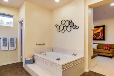 a large bathroom with a tub and a couch at 1 Mi to the Beach! Ocean-View Encinitas Home in Encinitas