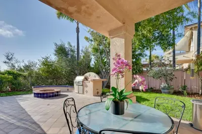 a patio with a glass table and chairs at 1 Mi to the Beach! Ocean-View Encinitas Home in Encinitas