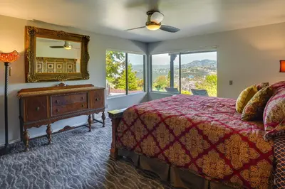 a bedroom with a bed and a mirror at Fallbrook Home with Mountain Views Close to Hiking! in Fallbrook