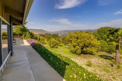 a walkway in front of a house with a garden at Fallbrook Home with Mountain Views Close to Hiking! in Fallbrook