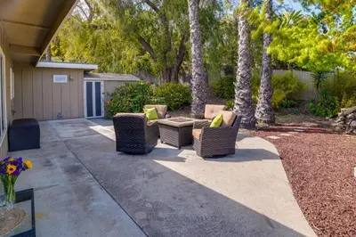 a patio with chairs and a table and trees at Fallbrook Home with Mountain Views Close to Hiking! in Fallbrook