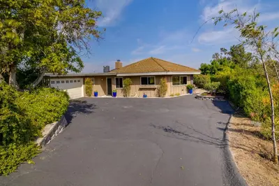 an empty driveway in front of a house at Fallbrook Home with Mountain Views Close to Hiking! in Fallbrook