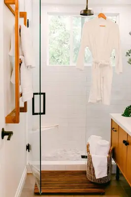 a bathroom with a shower with a robe on a window at Luxe OB Home, Walk to Beach, Sauna, and Backyard in San Diego