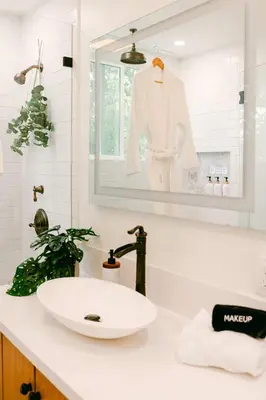 a white bathroom with a sink and a mirror at Luxe OB Home, Walk to Beach, Sauna, and Backyard in San Diego