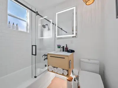 a bathroom with a sink and a shower and a toilet at Luxe OB Home, Walk to Beach, Sauna, and Backyard in San Diego