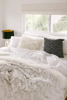 a white bed with white sheets and pillows and a window at Luxe OB Home, Walk to Beach, Sauna, and Backyard in San Diego